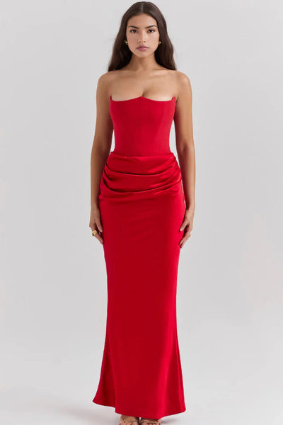 A woman wearing a black strapless maxi dress with a fitted bodice and a flowing skirt.